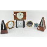 A group of five vintage mantel clocks and two metranones,