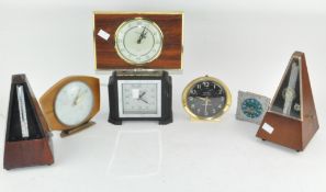 A group of five vintage mantel clocks and two metranones,