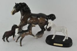 A group of four ceramic horses, including Beswick Shire horse,