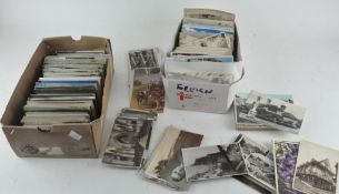 A large selection of vintage postcards in two boxes,