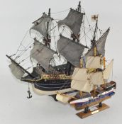 Two wooden model ships, each with two masts, both titled "the Golden Hind",