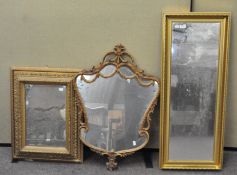 A group of three gilt framed mirrors of varing shapes and sizes,