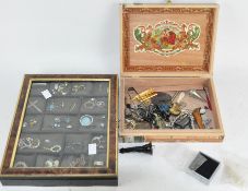 A cabinet containing various collectables and costume jewellery