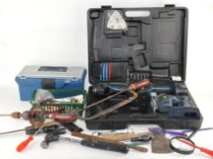 A collection of tools, to include a Metabo hand drill,