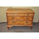 A walnut three drawer chest,