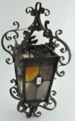 A vintage metal framed hanging lantern with glass panelling,