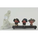 A novelty group of three carved wooden pourers in the form of smoking gentleman,