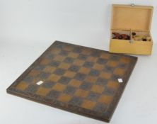 A 20th century carved wooden chess board with pieces