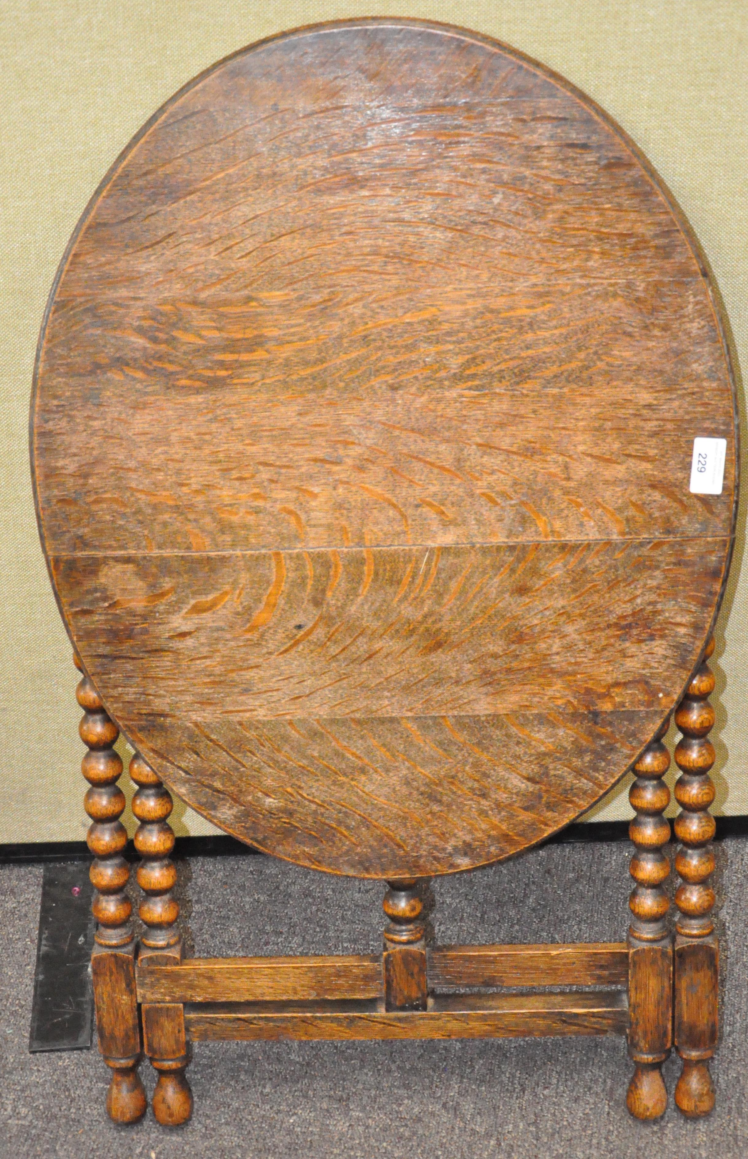 An oak bobbin turned table of folding form,