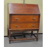 A 20th century oak bureau, the fall front door opening to reveal fitted inteior,