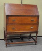 A 20th century oak bureau, the fall front door opening to reveal fitted inteior,