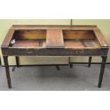 A large late 19th/early 20th century mahogany double school desk,
