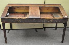 A large late 19th/early 20th century mahogany double school desk,