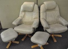 Two Stressless style armchairs with original footstools,