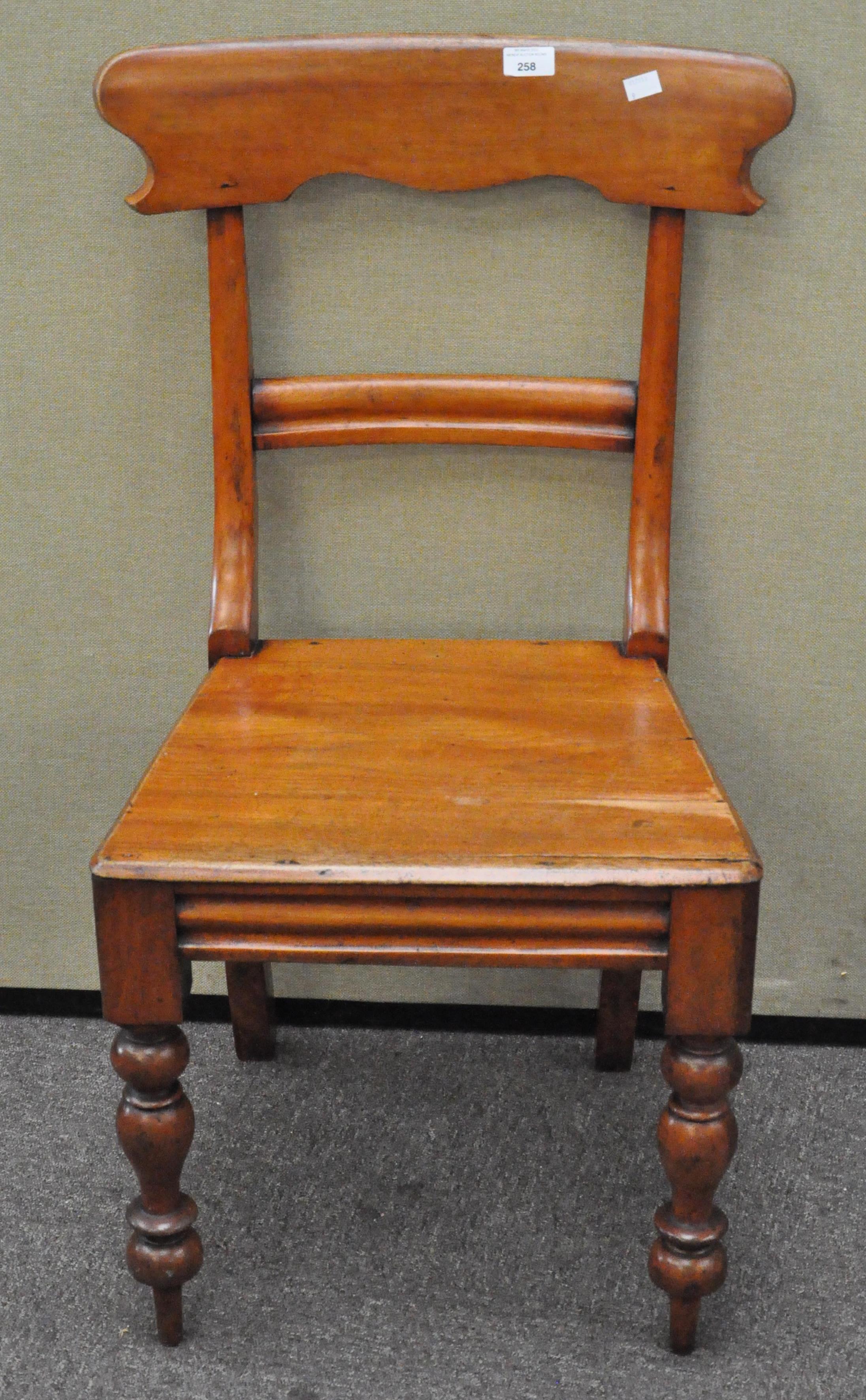 A 19th century mahogany dining chair raised upon turned supports,