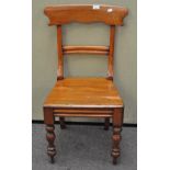 A 19th century mahogany dining chair raised upon turned supports,