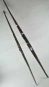 Two vintage wooden bows, lacking arrows,