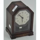 A mid century oak cased 'Bulle' clock, the dial with Arabic numerals denoting hours,
