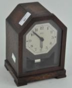 A mid century oak cased 'Bulle' clock, the dial with Arabic numerals denoting hours,