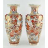 A pair of Japanese satsuma style vases depicting traditional scenes,