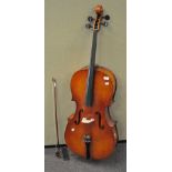 A cello and bow, lacking two strings,