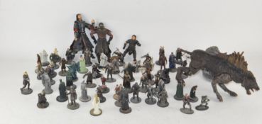 A collection of Lord of the Rings metal and resin figures with books,