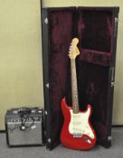 A Squire red electric guitar, in velvet-lined hard case,