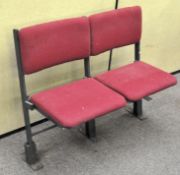 A two seat cinema seat with folding front, mounted to metal stand,