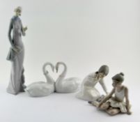 A collection of Lladro figures, including: a pair of conjoined swans,