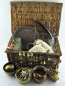 A wicker case containing various collectables, to include a telephone,