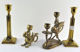 Two brass candlesticks in the form of Griffins,