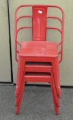 A set of three red Tolix style stacking chairs,