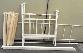 A white painted single bed frame with wooden slats