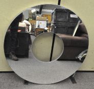 A large circular 'polo' shaped wall mirror, previously retailed at Dunelm,