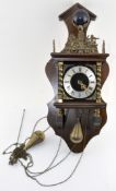 A vintage Dutch wall clock, the top adorned with a finial in the form of Atlas,