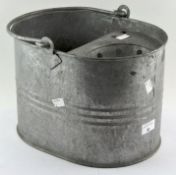 A galvanised metal mop bucket