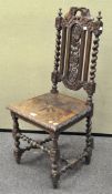 An oak hall chair with highly carved with foliate decoration,