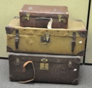 A group of three vintage suitcases,