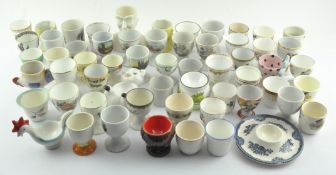 A collection of assorted ceramic egg cups, mostly early 20th century,