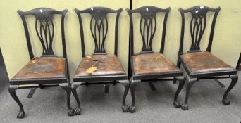 A set of four dining chairs raised upon claw and ball feet,