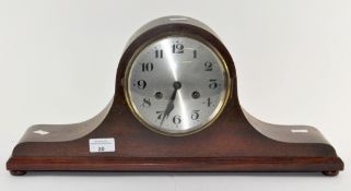 A mid-century mahogany cased mantel clock, the metal dial with Arabic numerals denoting hours,