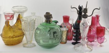 A large collection of assorted glassware including cranberry and green examples,