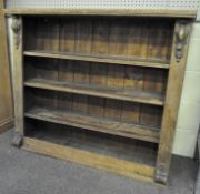 A late 19th/early 20th century oak bookshelf, the front adorned with carved motifs, four tier,
