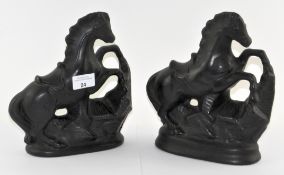A pair of glazed ceramic figures of horses,