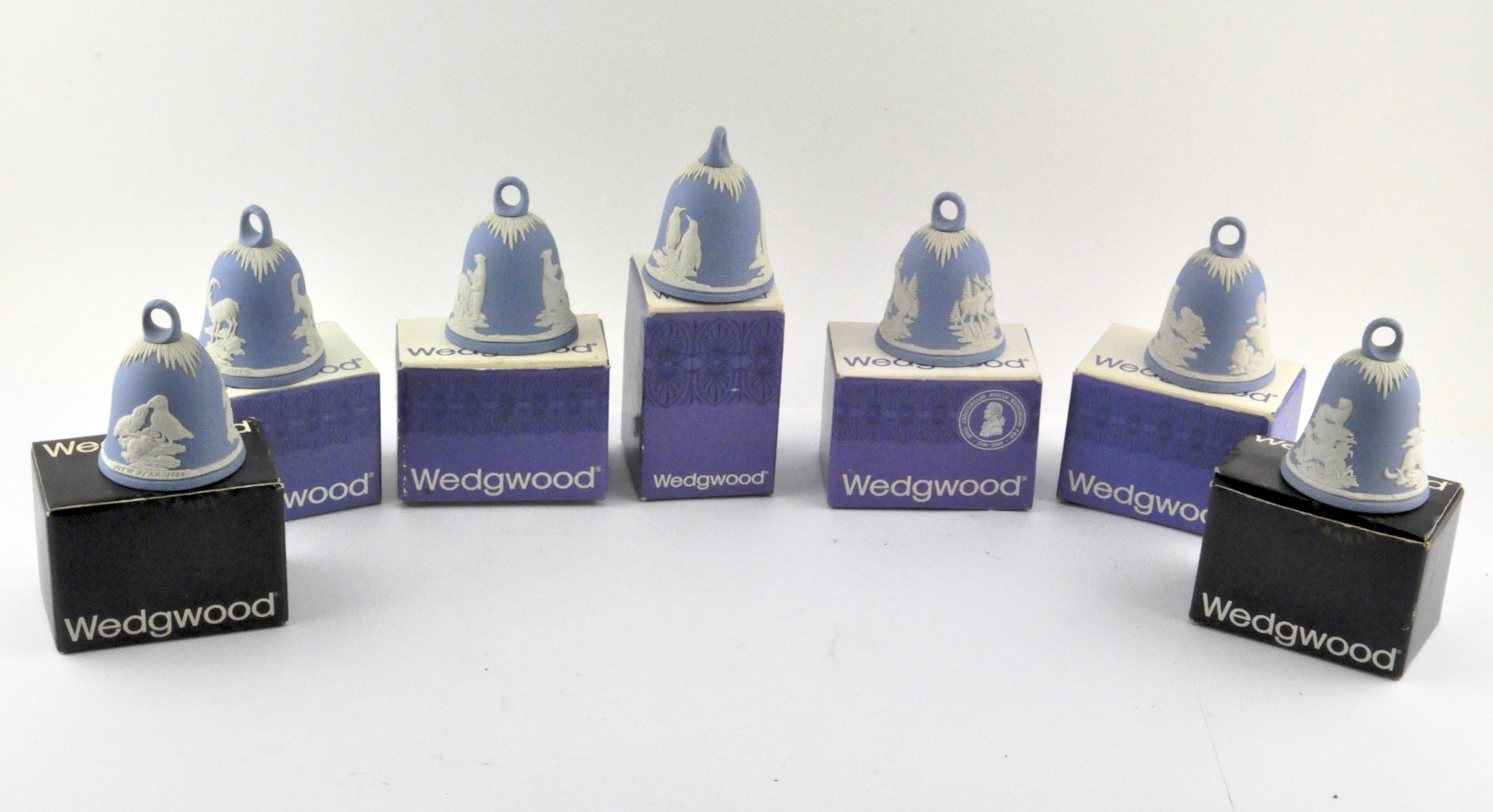 Seven Wedgwood blue and white Jasperware Annual dated New year Bells, boxed,