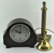 An oak cased mantel clock, together with a brass lamp base in column form,