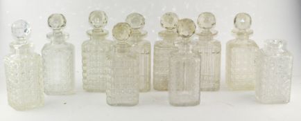 A collection of cut and moulded glass spirit decanters and stoppers, some with hobnail pattern,