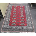 A red and black wood rug, 20th century, with geometric ornament,