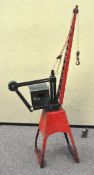 A large vintage home made metal model of a mechanical crane,