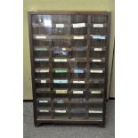 A stained oak glazed collector's display cabinet, with pigeon holes,